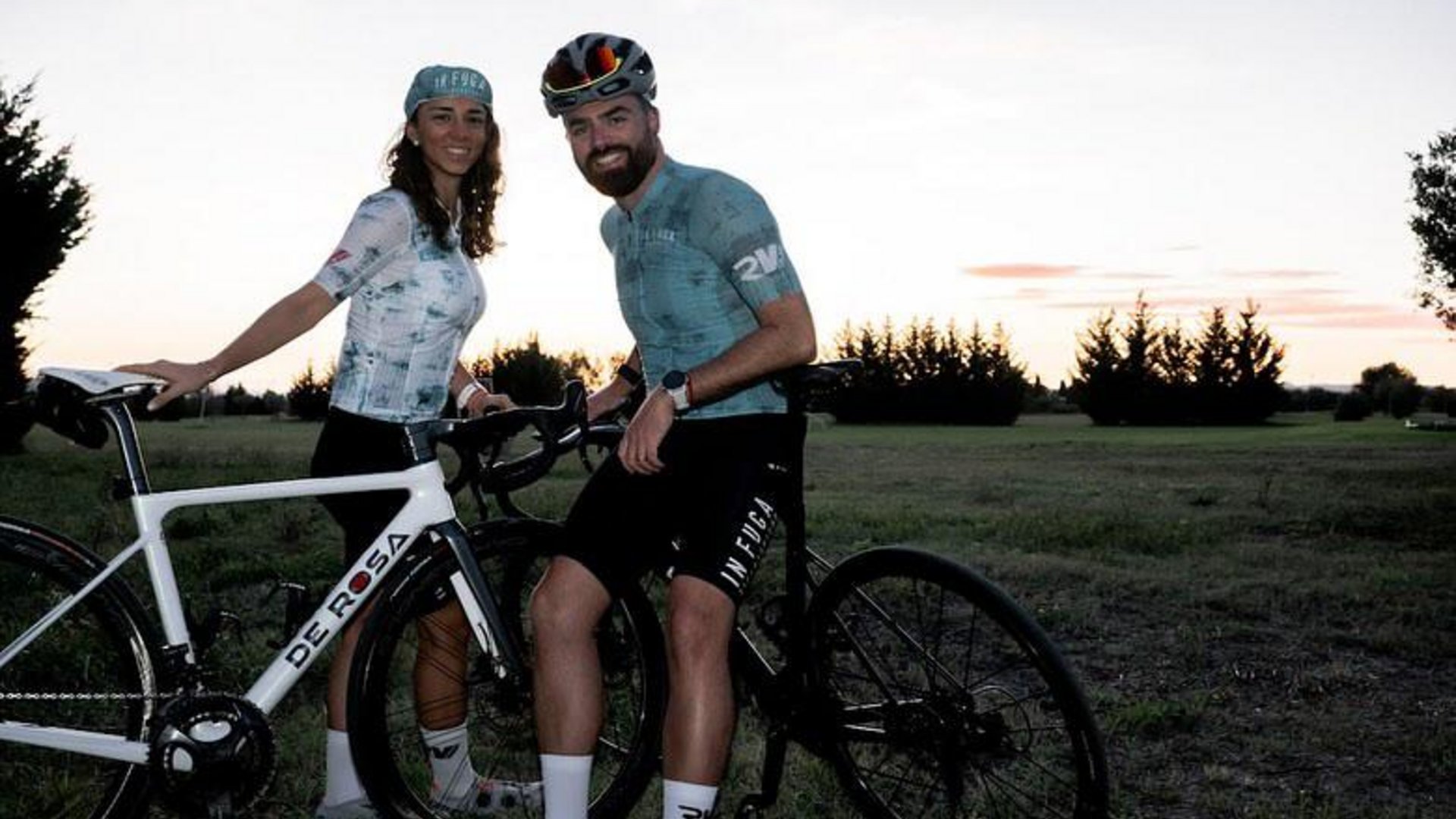 A holiday near Assisi: activities galore Man and woman with road bikes in a field at sunset