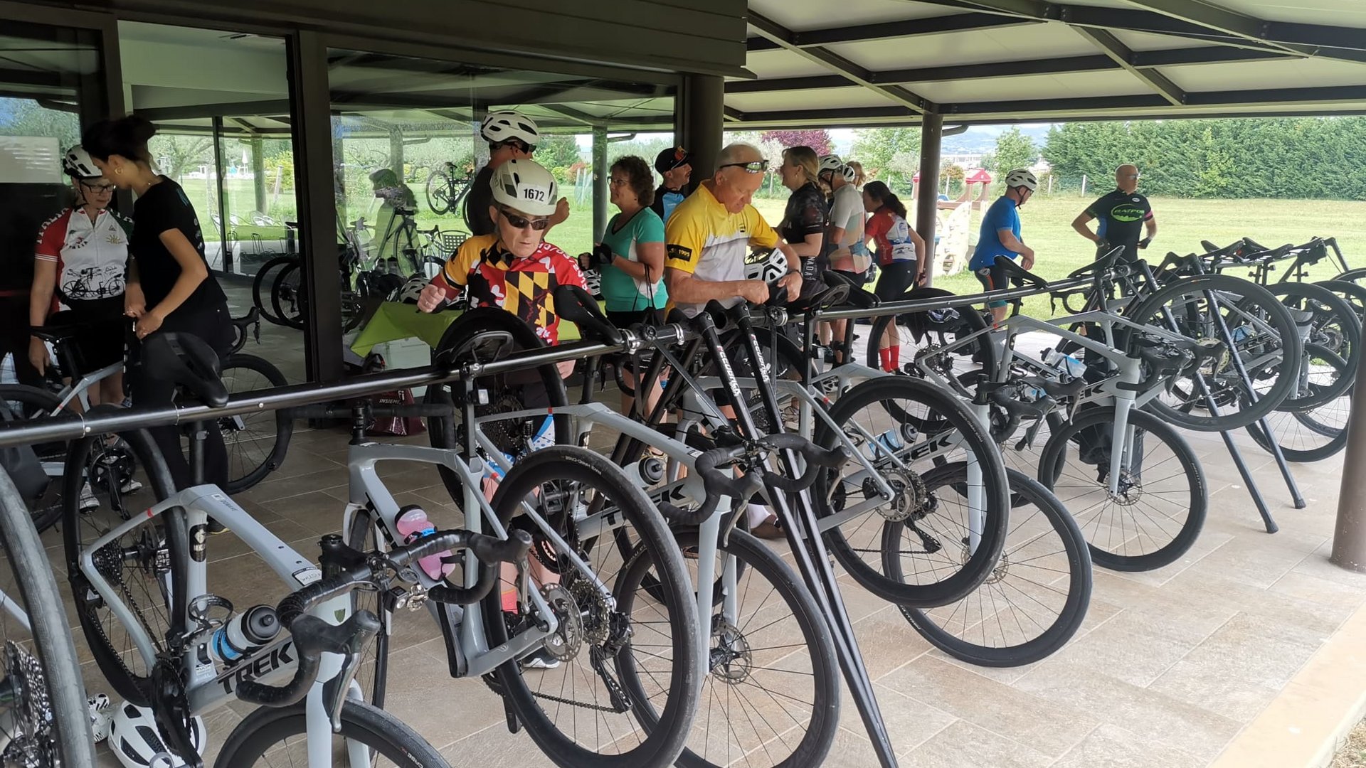 A holiday near Assisi: activities galore People with cycling gear near bikes parked under a shelter