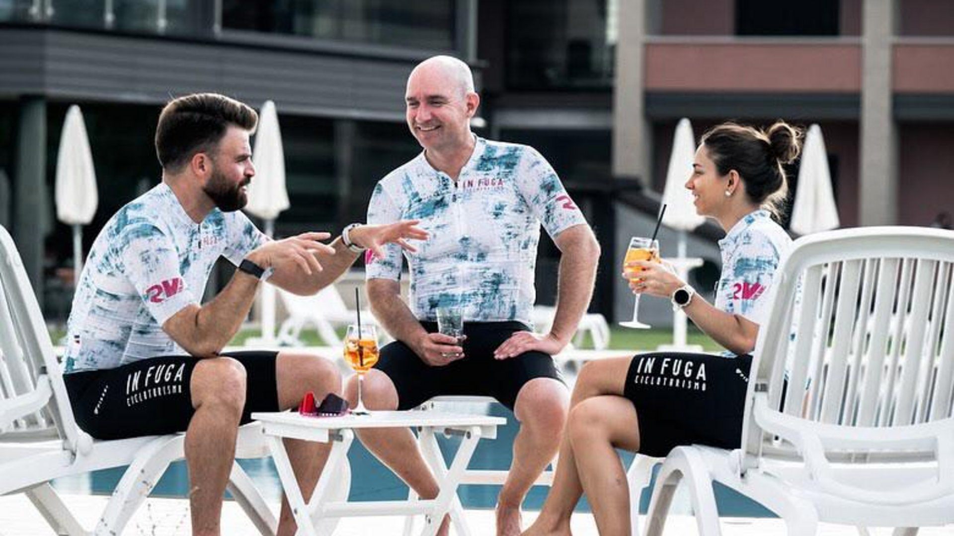 A holiday near Assisi: activities galore Three cyclists sitting by the pool with drinks and cycling apparel