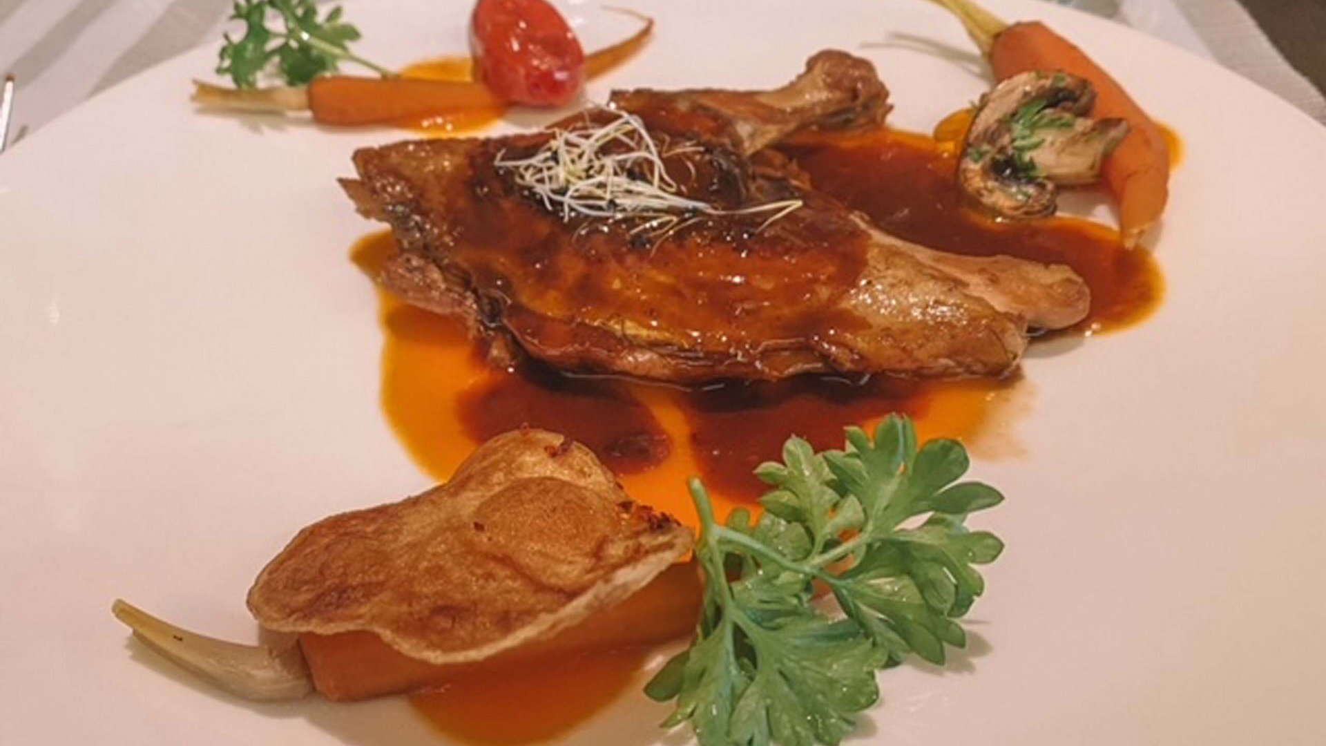 A holiday near Assisi: activities galore Duck breast with sauce, carrots, tomato and mushrooms on white plate