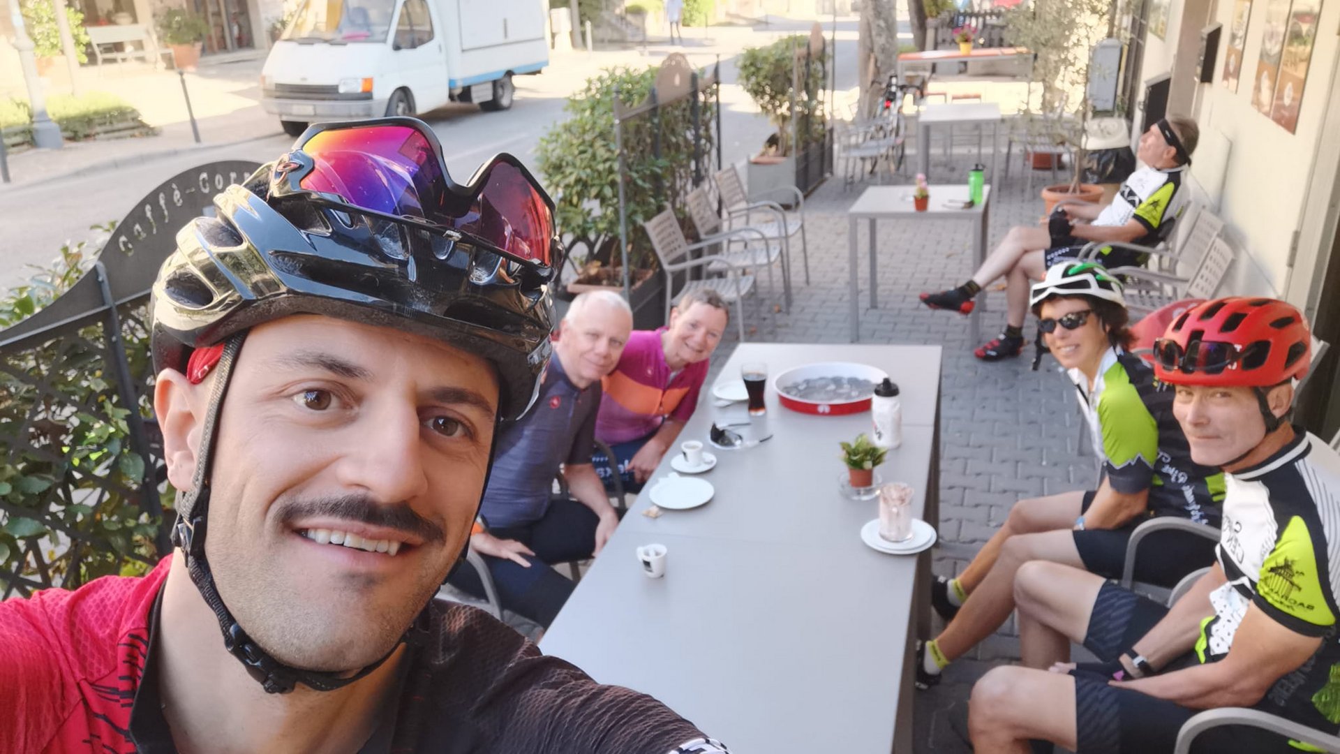 A holiday near Assisi: activities galore Group of cyclists sitting at an outdoor table during a coffee break