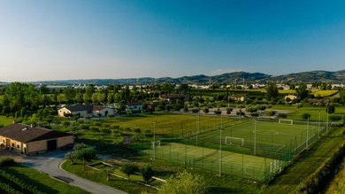A holiday near Assisi: activities galore Sports fields in green area with mountains in the background