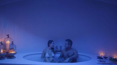 Your spa near Assisi: Assisi Cantico Spa Couple relaxing in hot tub with candles and wine glasses