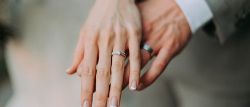 Valle di Assisi Celebrates New Olive Oil: Simultaneous Parent-Child Massage Woman's hand with engagement ring and man's hand with wedding band