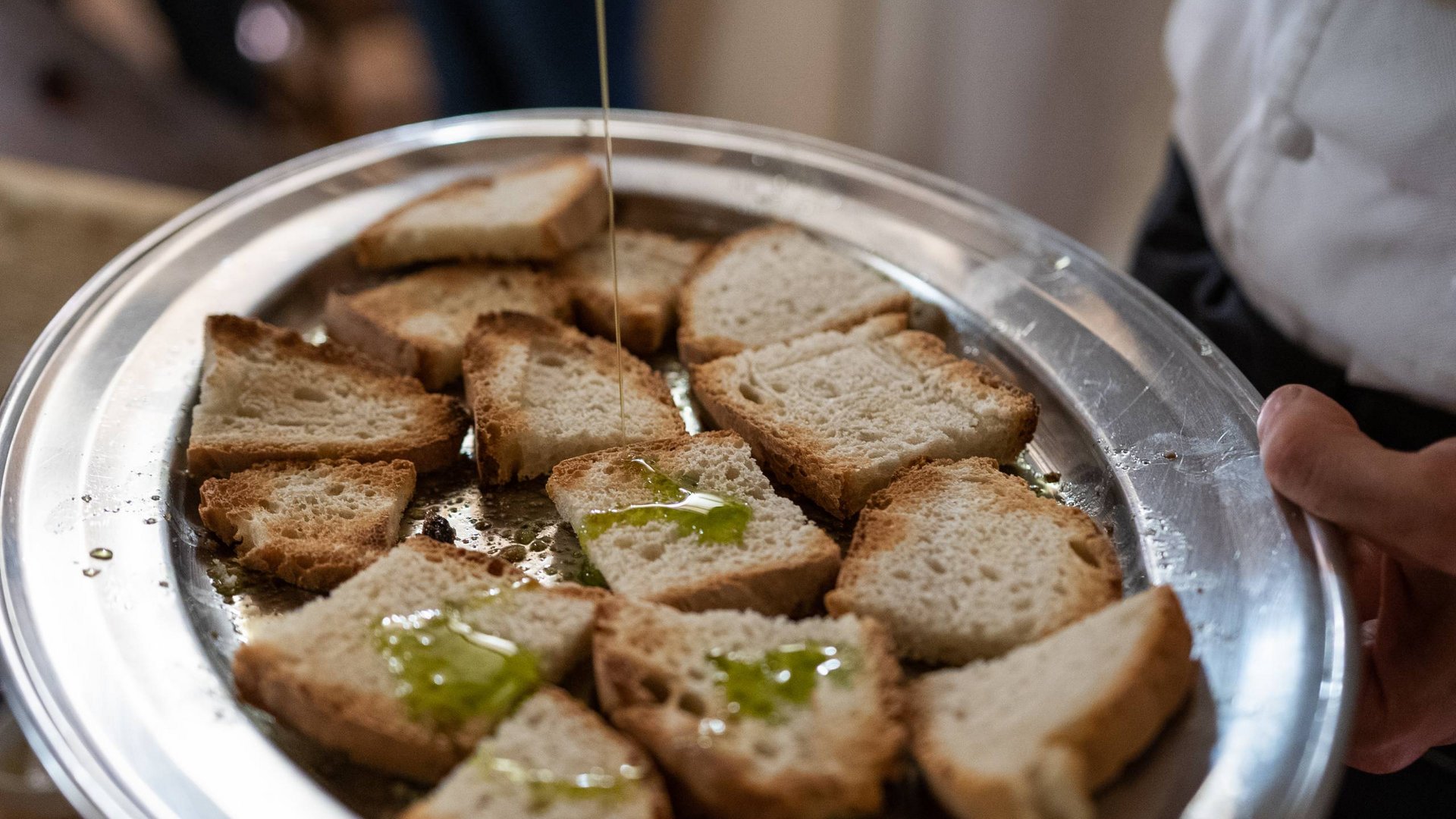A holiday near Assisi: activities galore Slices of toasted bread with olive oil being poured on a plate