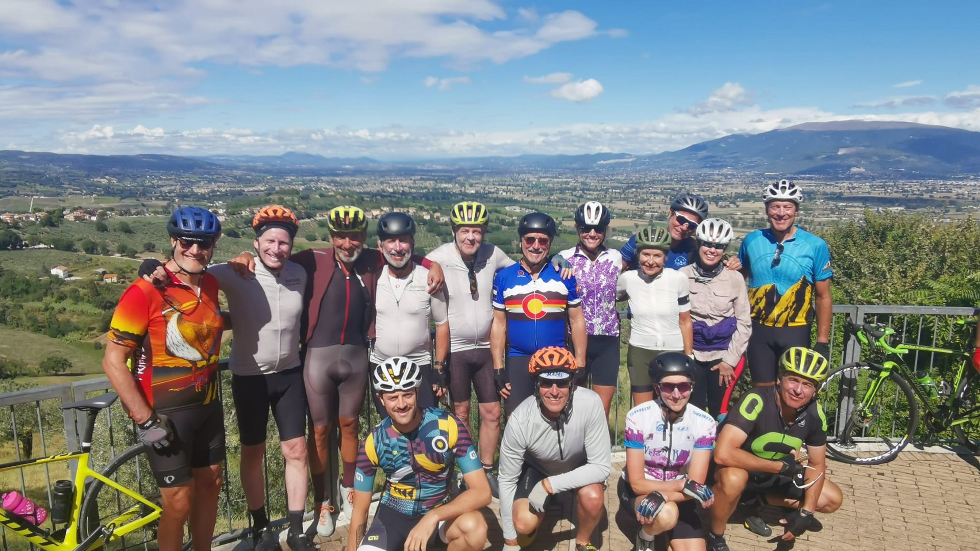 A holiday near Assisi: activities galore Group of cyclists in sportswear with hilly landscape in the background